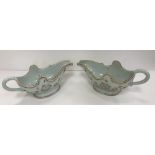 A pair of late 18th/early 19th Century Chinese porcelain sauceboats of inverted helmet form, the