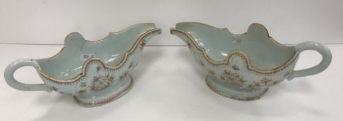 A pair of late 18th/early 19th Century Chinese porcelain sauceboats of inverted helmet form, the