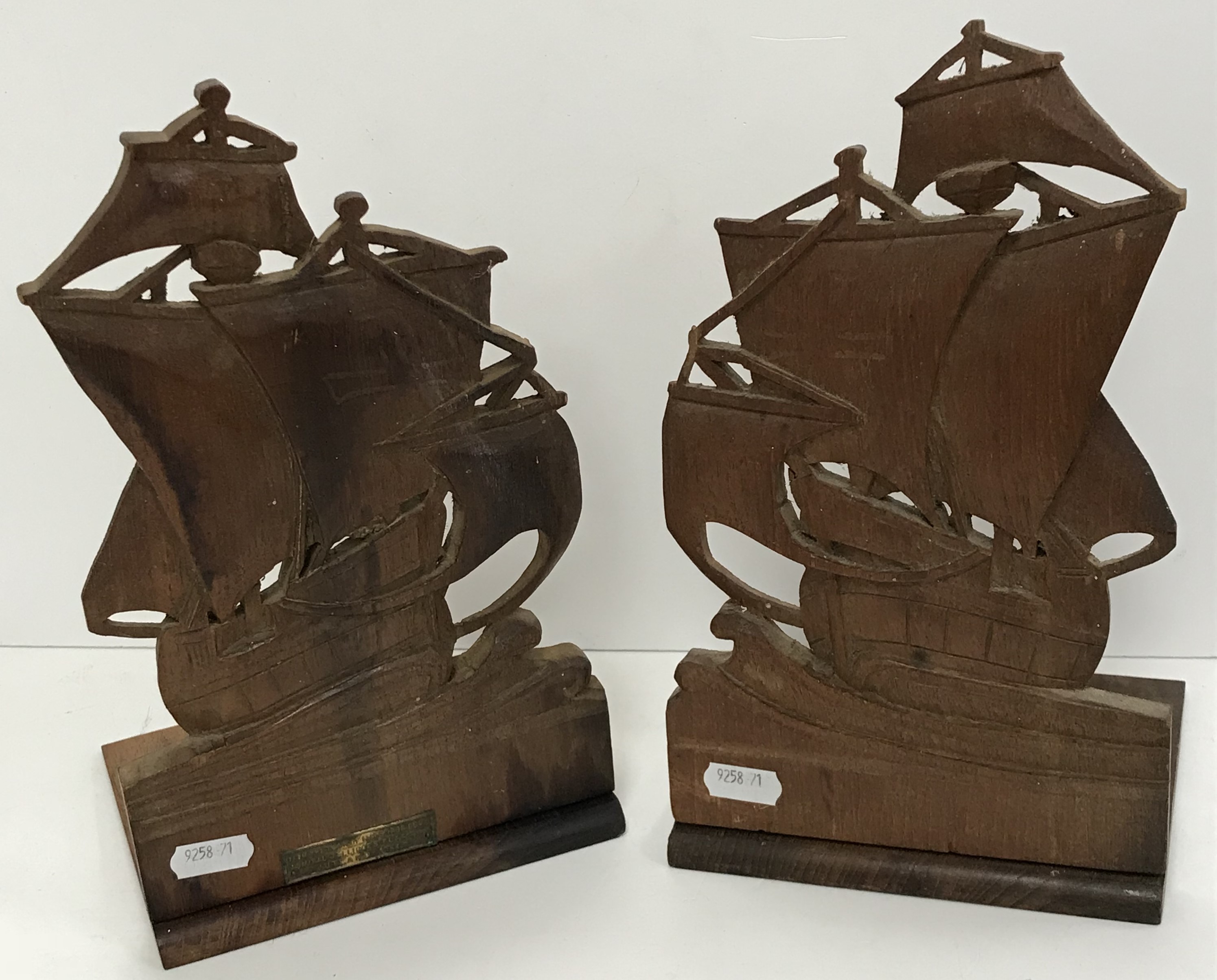 A pair of carved teak ''Ship'' bookends bearing embossed brass plaque inscribed ''From the teak of