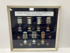 A framed and glazed collection of ROSPA National Safe Driving Competition Awards and lapel badges