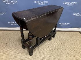 An oak oval gate leg drop leaf dining table in the 17th Century manner on turned supports to