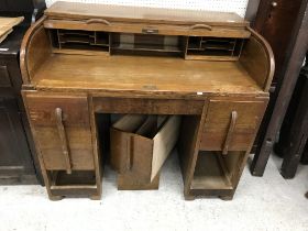 A mid 20th Century Scottish oak tambour top desk by Menstrigood, the upper section with basic fitted
