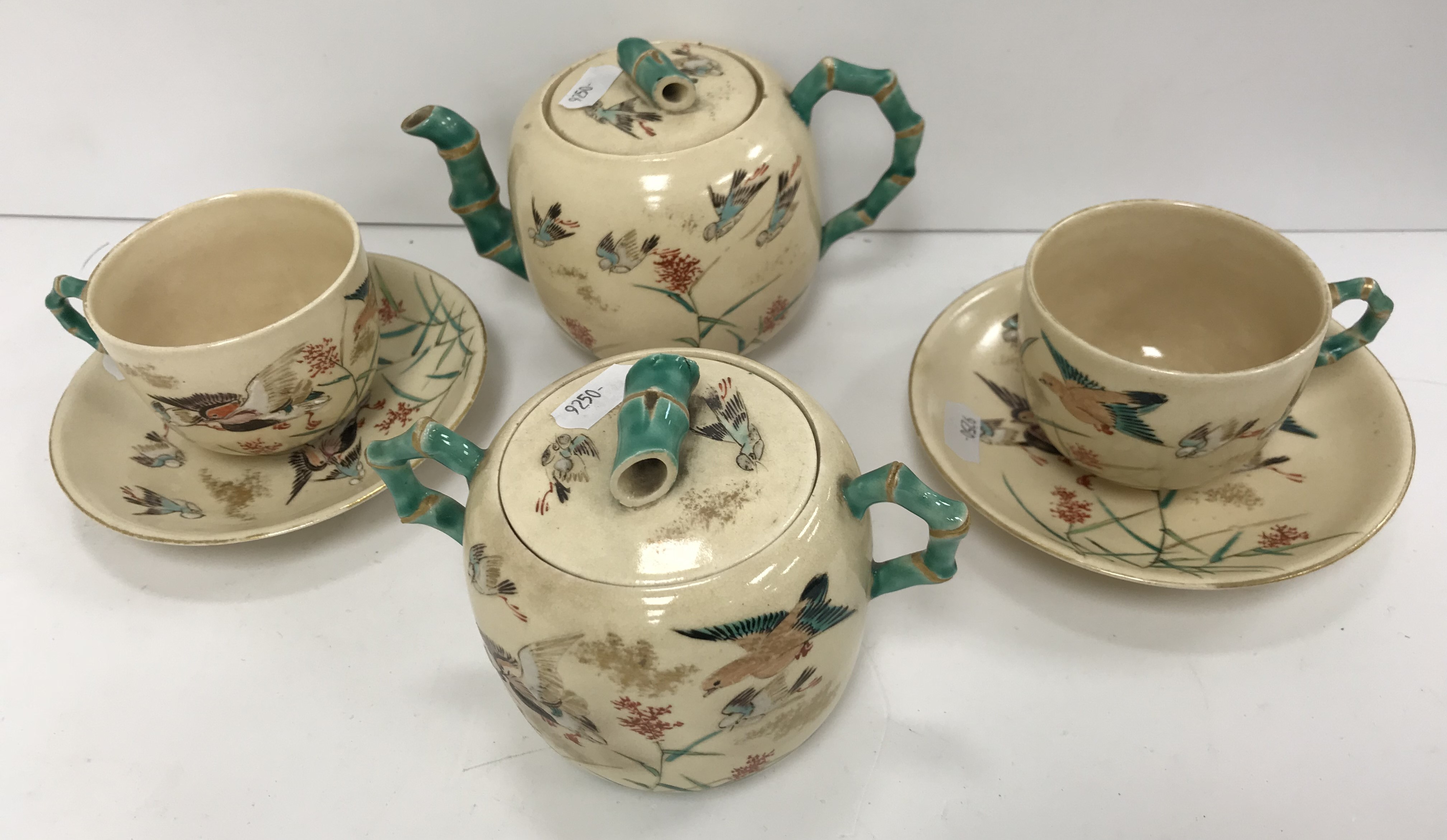 A Japanese Meji period satsuma ware part tea set comprising tea pot and sucriere with bamboo handles