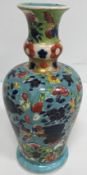 An 18th Century Chinese polychrome decorated vase with flared Gu style neck above a turquoise ground