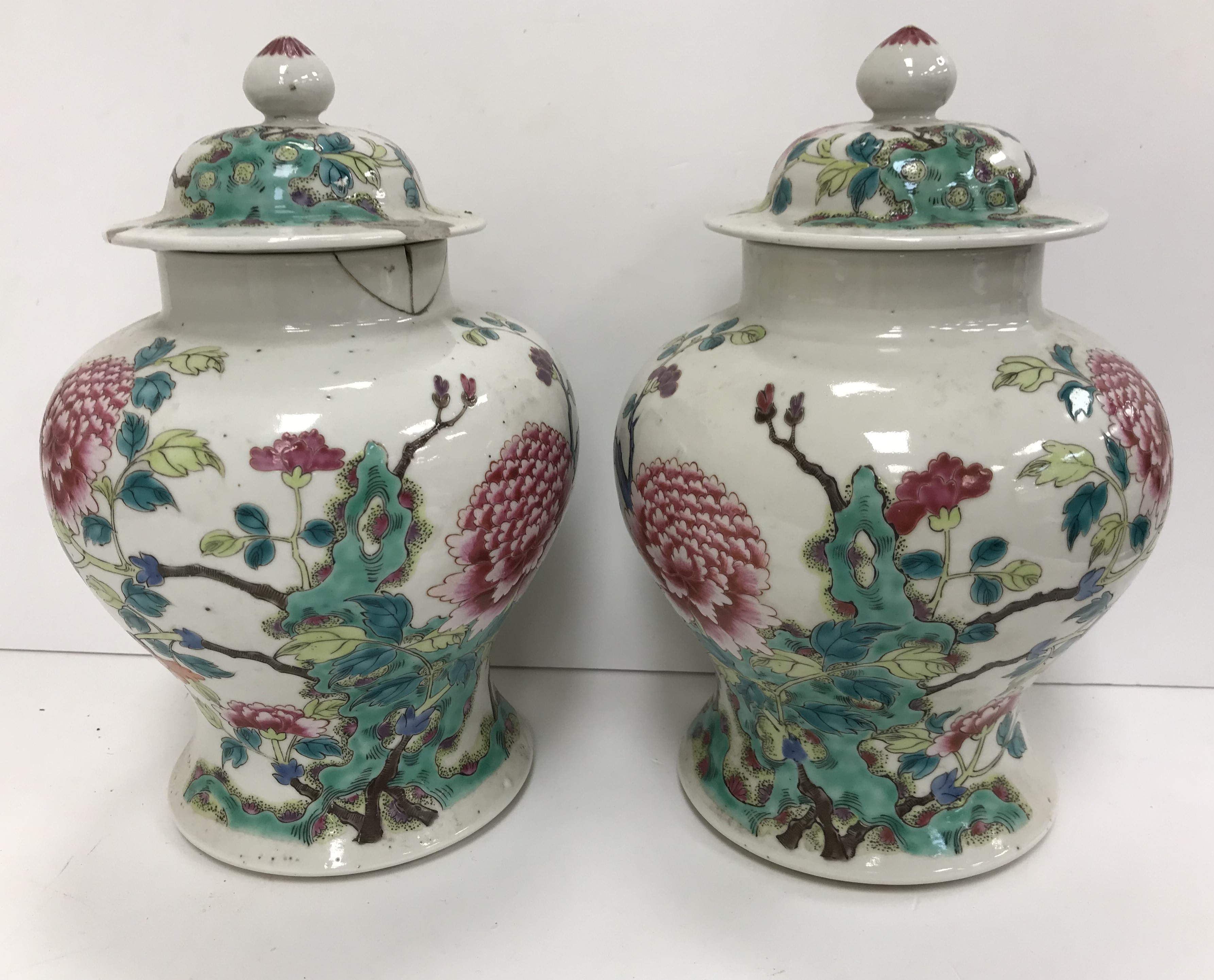 A pair of 19th Century Chinese famille rose vases and covers, the main body decorated with