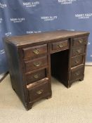 A Victorian stained pine and beech framed kneehole desk, the writing surface over a central slim