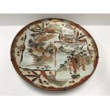 A Japanese Meiji Period Kutani charger with figural and exotic bird panel decoration, bearing