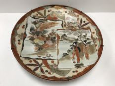 A Japanese Meiji Period Kutani charger with figural and exotic bird panel decoration, bearing