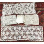 A 1930s crocheted table runner, set of place mats and matching napkins and a further similar set