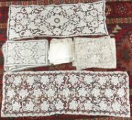 A 1930s crocheted table runner, set of place mats and matching napkins and a further similar set