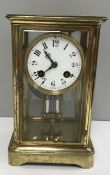 A brass cased mantle clock of rectangula