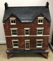 A Victorian style dolls' house, the hinged front opening to reveal six rooms and a stairwell,