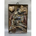 A wood panel carved in relief with the King of Hearts, picked out in gilt, silver, red and blue,