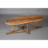 Italy 1950s, a canework coffee table, oval, on four curved legs, 148cm long x 57cm wide x 47cm high