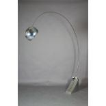 An aluminium floor lamp in the style of Arco, having a curved extending arm with spherical shade,