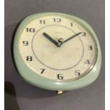 A Smiths wall clock c.1960s in pale blue plastic case, sunburst to the cream dial and black Arabic