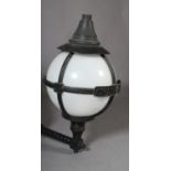 A large white perspex and black metal spherical light on bracket arm, the enclosing framework with