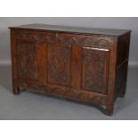 AN 18TH CENTURY OAK JOINED CHEST, the planked top with slot in fastening demi-lune carved frieze and