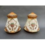 A pair of early 20th century milk glass lamp shades tinted in orange and green with flowerheads in