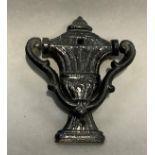 A 19th century cast iron urn-shape door knocker, 14cm high x 12cm deep