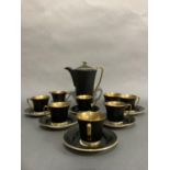 A Crown Devon coffee service of black and gilt comprising coffee pot, six coffee cups and saucers,