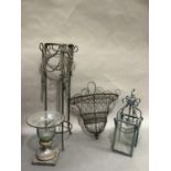 A black wire mesh wall hanging planter, a metal and brass vase, a Verdigris finished lantern and a