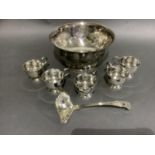 A good silver plated punch bowl with six cups and ladle, embossed with flowers and blind cartouche,