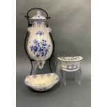 A continental blue and white cistern and cover and matching bowl on a metal wall frame together with