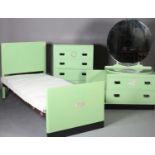 An Art Deco green and black bedroom suite: the dressing chest having a large circular mirror, over