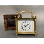 A gilded brass carriage clock having a white enamelled dial with black Roman numerals, exposed
