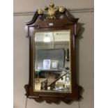 A reproduction 18th century style mahogany wall mirror having broken arch pediment and gilded Prince