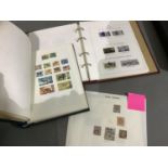 Two stamp albums in blue and burgundy containing stamps from Australia, Antigua, Barbados,