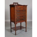 AN Edward VII mahogany and satinwood banded music cabinet having a raised and pierced three-