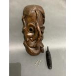 A large carved African mask and a smaller ebonised mask