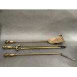 A set of three brass fire irons, tongs, shovel and poker (poker at fault)
