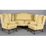 A Sofa and pair of winged armchairs, each with arched back and scroll arms, upholstered in soft