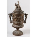 A 19TH CENTURY BRONZED METAL BACCHANALIAN TWO HANDLED CUP AND COVER, having a figural finial, the