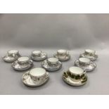 A set of six 19th century china cups and saucers bordered in polychrome enamels with leaf scrolls,
