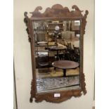 An 18th century style mahogany fret cut wall mirror with rectangular glass measuring 63cm x 39cm