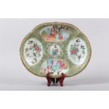 A 19th century Chinese famille rose dish of oval shaped form, painted with figures on a garden