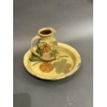 An earthenware platter and jug, the pale yellow glaze decorated with gourds and leafage