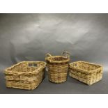 Two wicker baskets of graduated rectangular shape with handle grips and a circular two handled