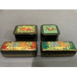 Four hand painted Russian black lacquered boxes of square and rectangular outline painted with