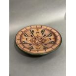 A terracotta bowl, circular, painted in the Moroccan style in green, burgundy, ochre, green and