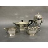 A mid 20th century silver plated three piece tea service of irregular octagonal form cast within a