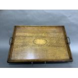 An Edwardian oak two handled tray of rectangular outline inlaid to the centre in satinwood and