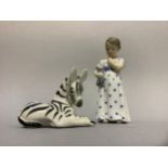 A Royal Copenhagen figure of a girl with teddy bear and a USSR china figure of a zebra