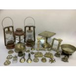 Three hurricane lamps and a quantity of brass ware
