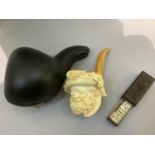 A modern Meerschaum pipe, the bowl carved as a grinning bearded man with feathered hat, in fitted