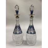 A pair of George V fluted and hob nail cut glass decanters etched with a band of grape vines with